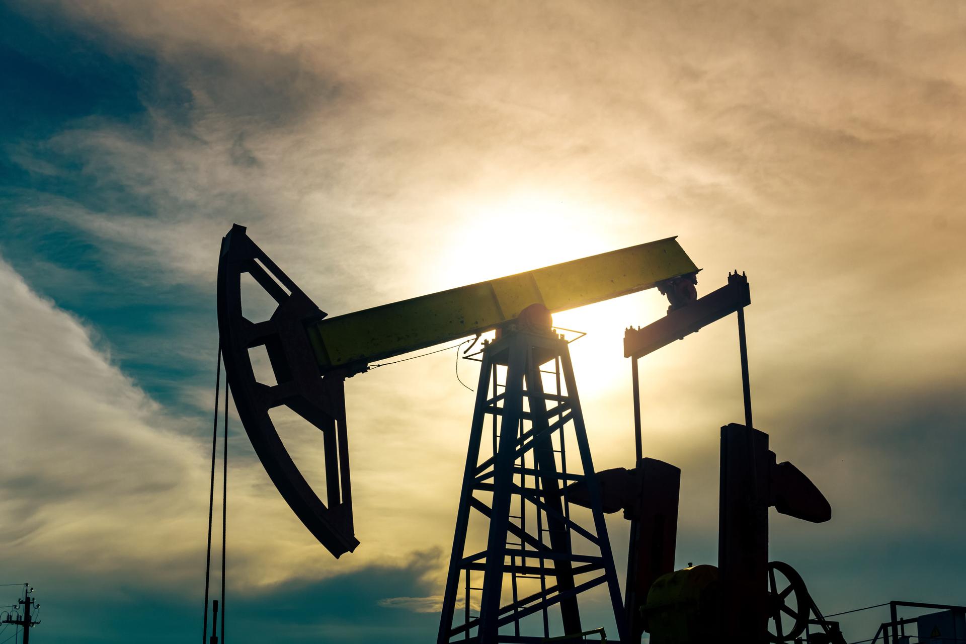 silhouette of pumping stations on an oil well against the background of sky