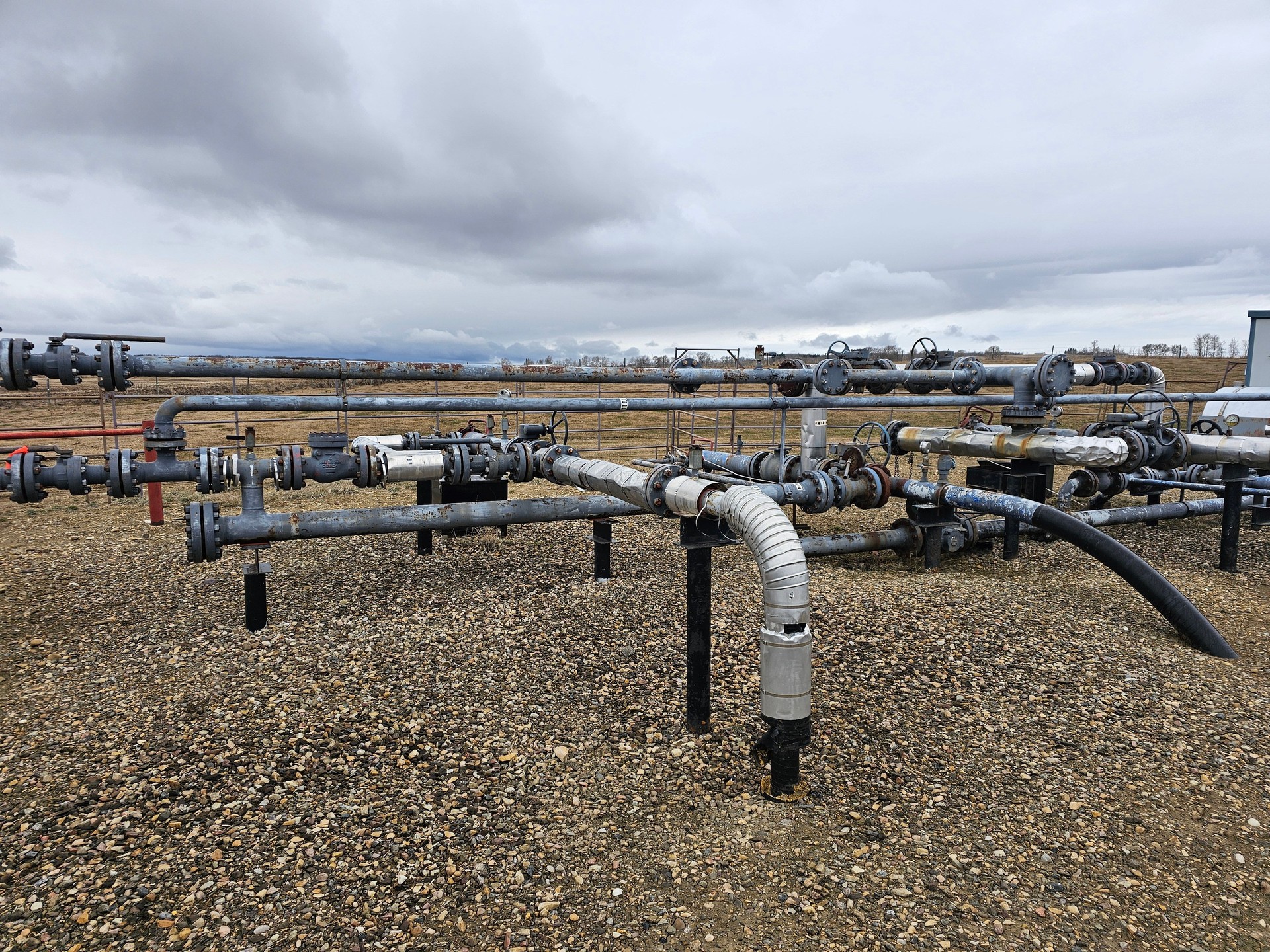 Oil pumping site with pipes running in different directions.